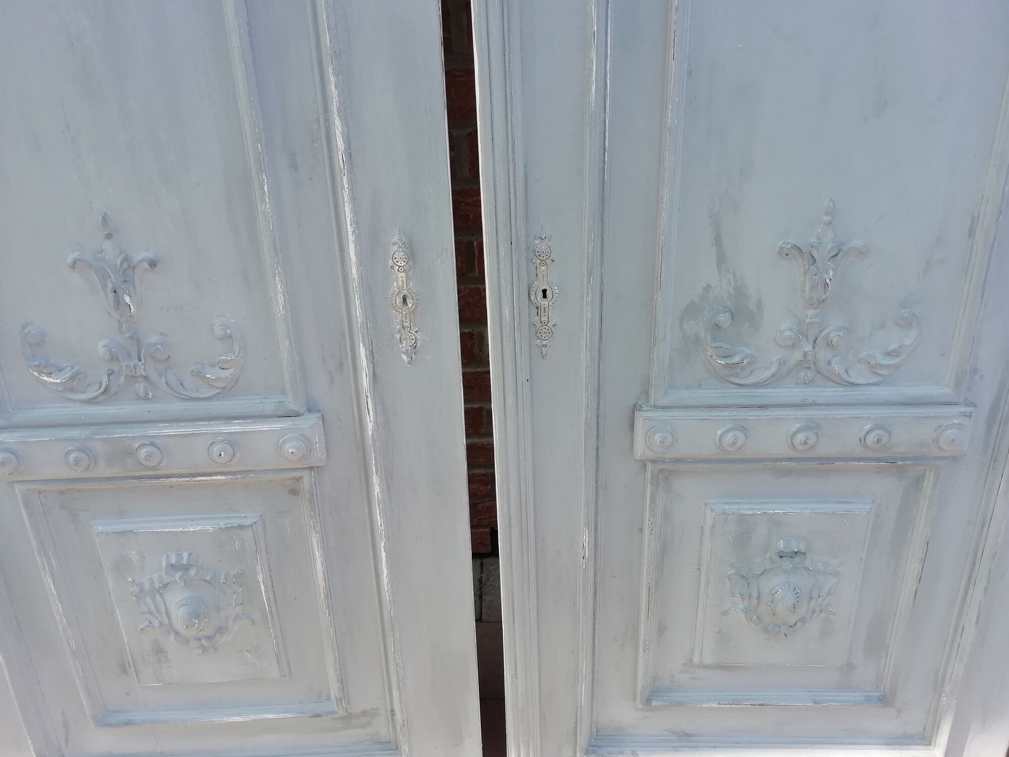 Pair of old door painted in carved wood