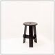Vintage black-stained wooden tripod stool with mortise joints.