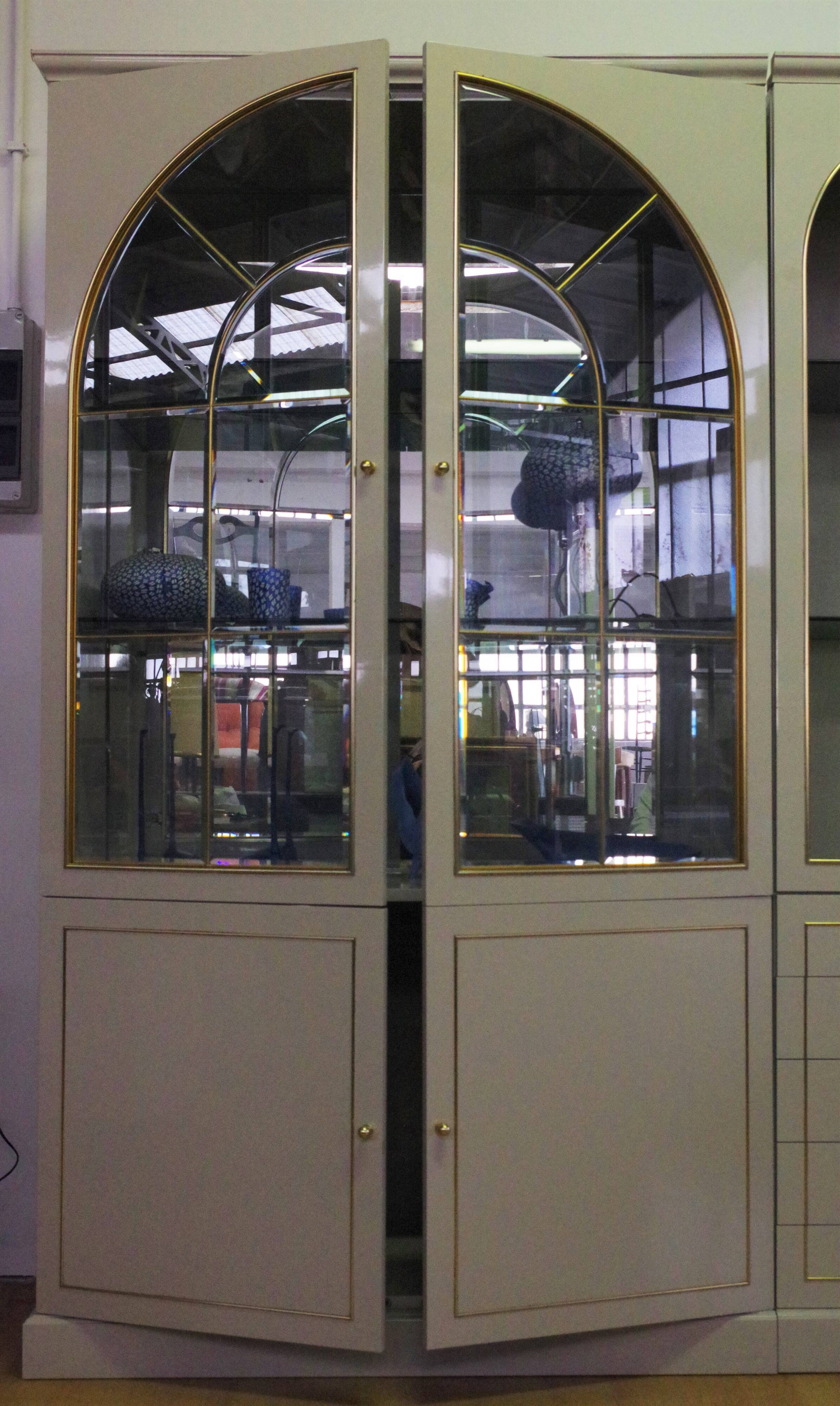 Showcases in lacquered wood, glass and brass  1970s, set of 4