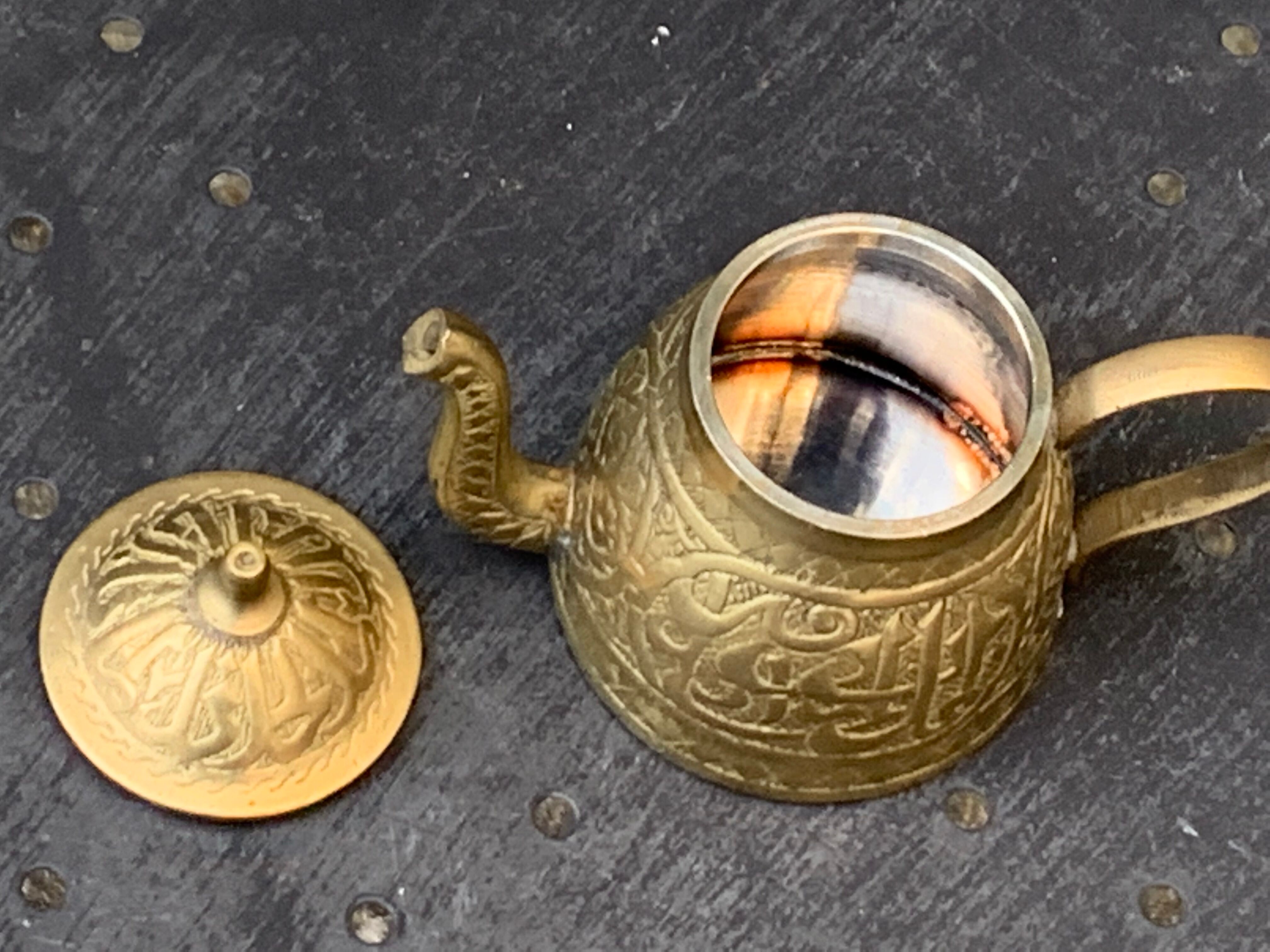 Small decorative teapot in vintage chiseled copper