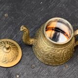 Small decorative teapot in vintage chiseled copper