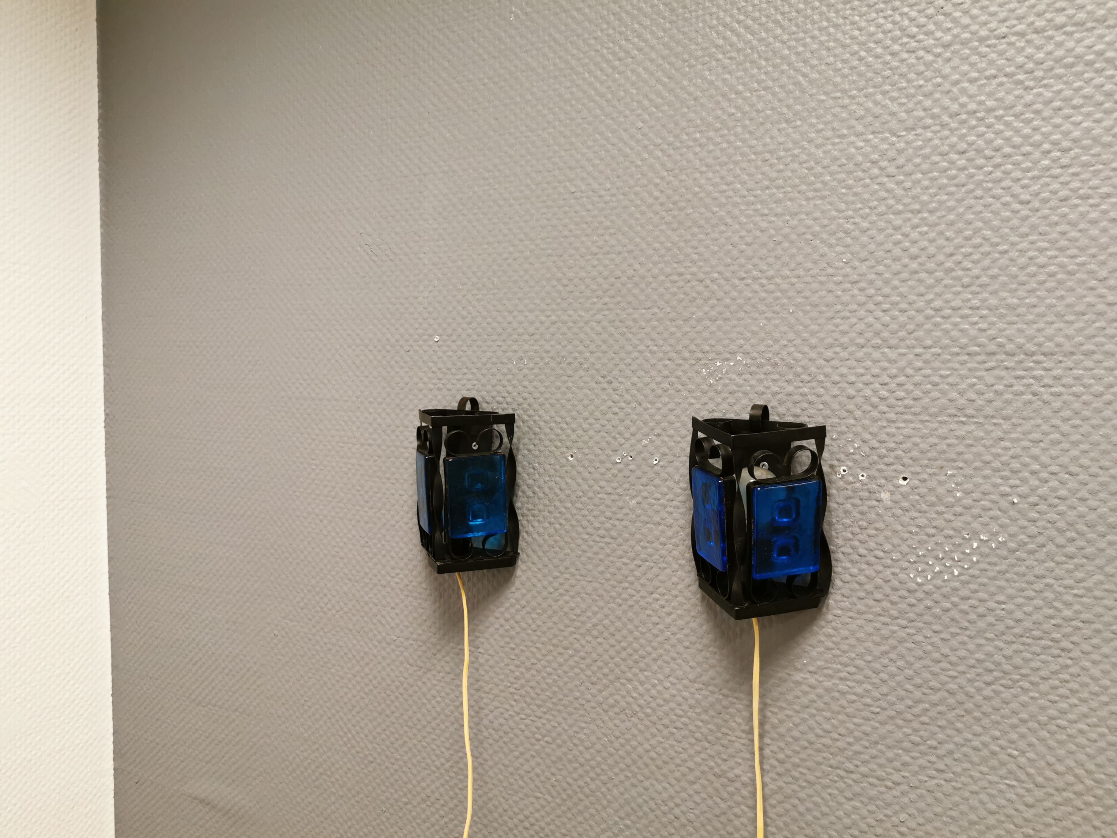 Wall lamps made of black cast iron and handmade thick pressed blue glass