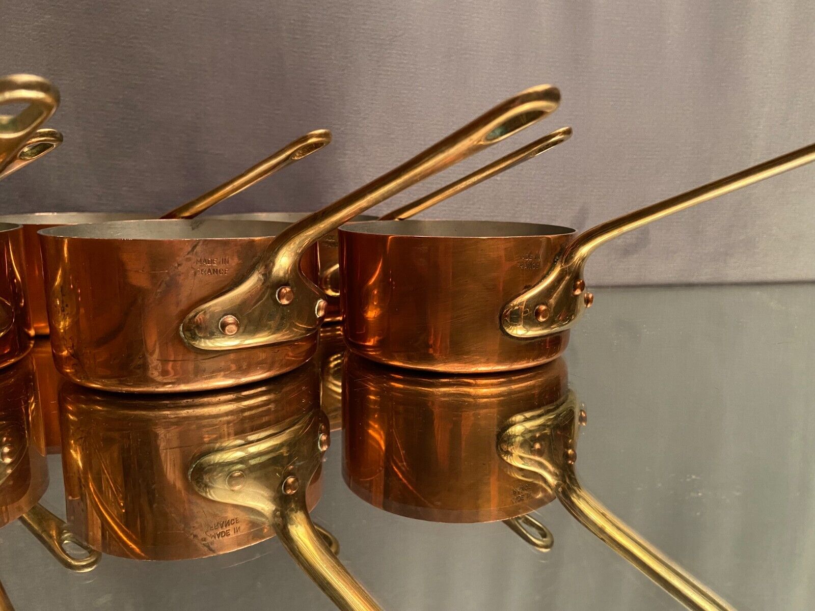 Suite of 12 tinned copper pans