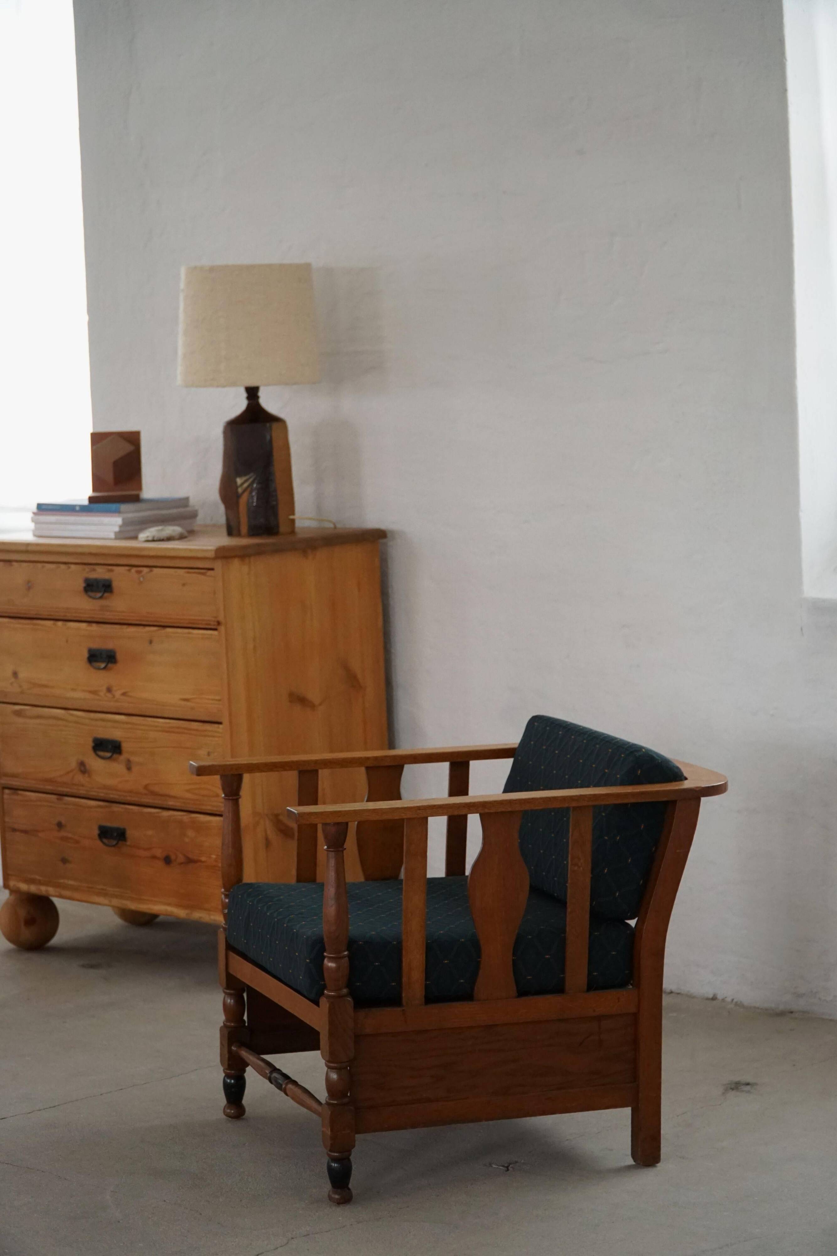Art Nouveau, pair of oak lounge chairs, reupholstered in style fabric, 1920s.