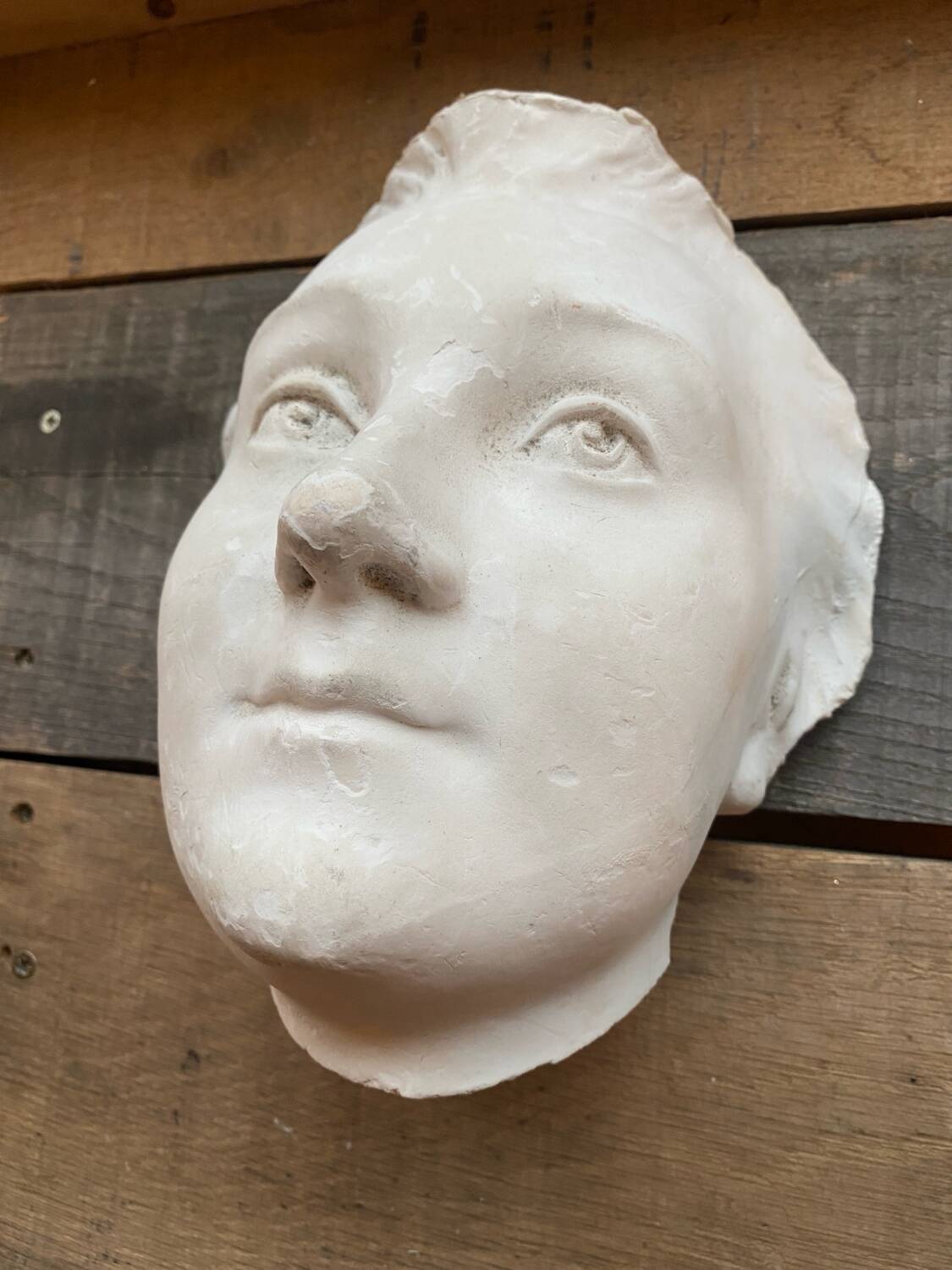 Plaster face wall statue