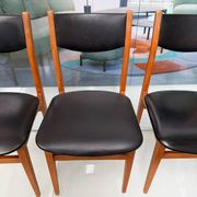 4 Scandinavian chairs in teak and black faux leather.