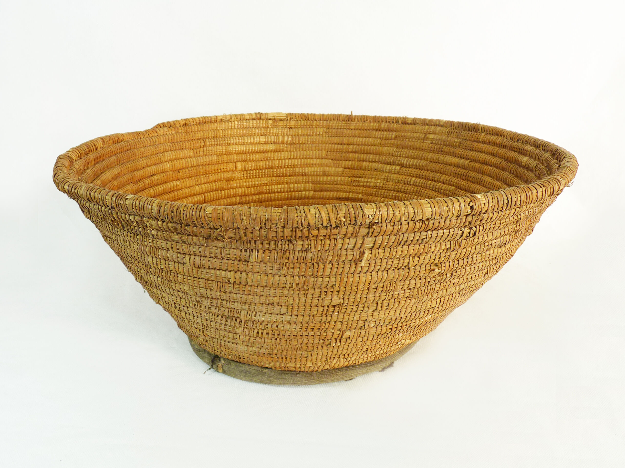 Old large bread basket of baker in braided wicker