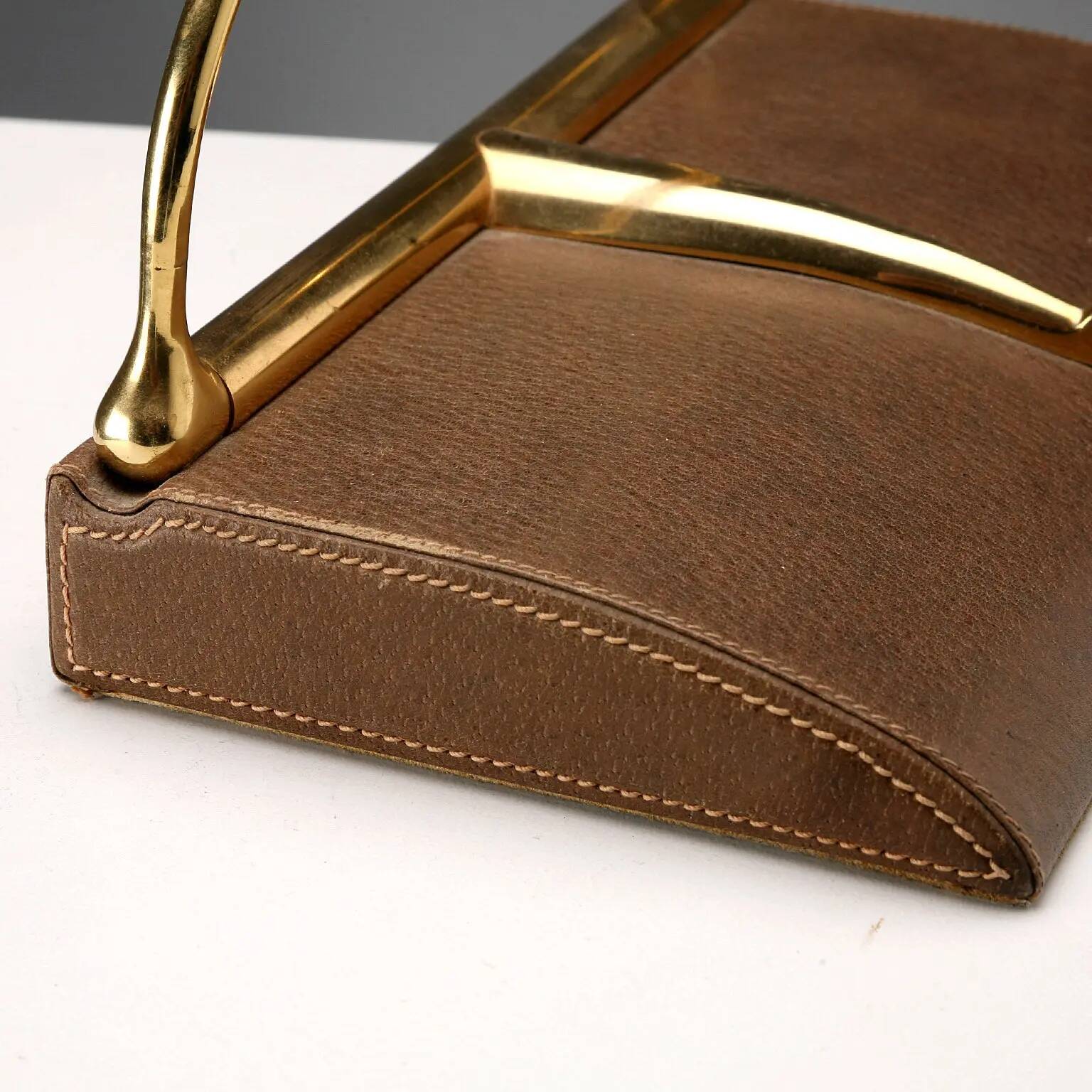 Vintage Gucci bookends in leather and brass, Italy, 1970s.