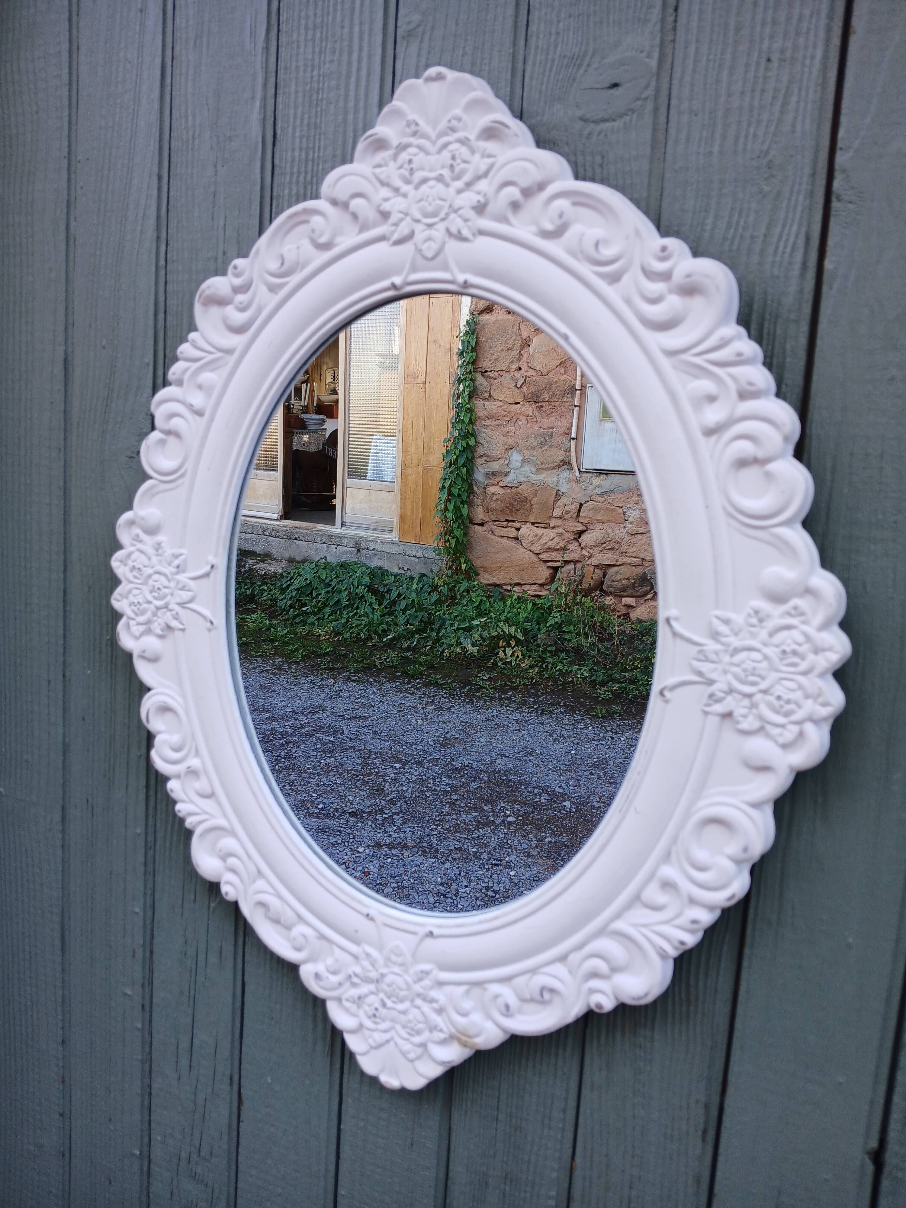 Oval mirror with white frame