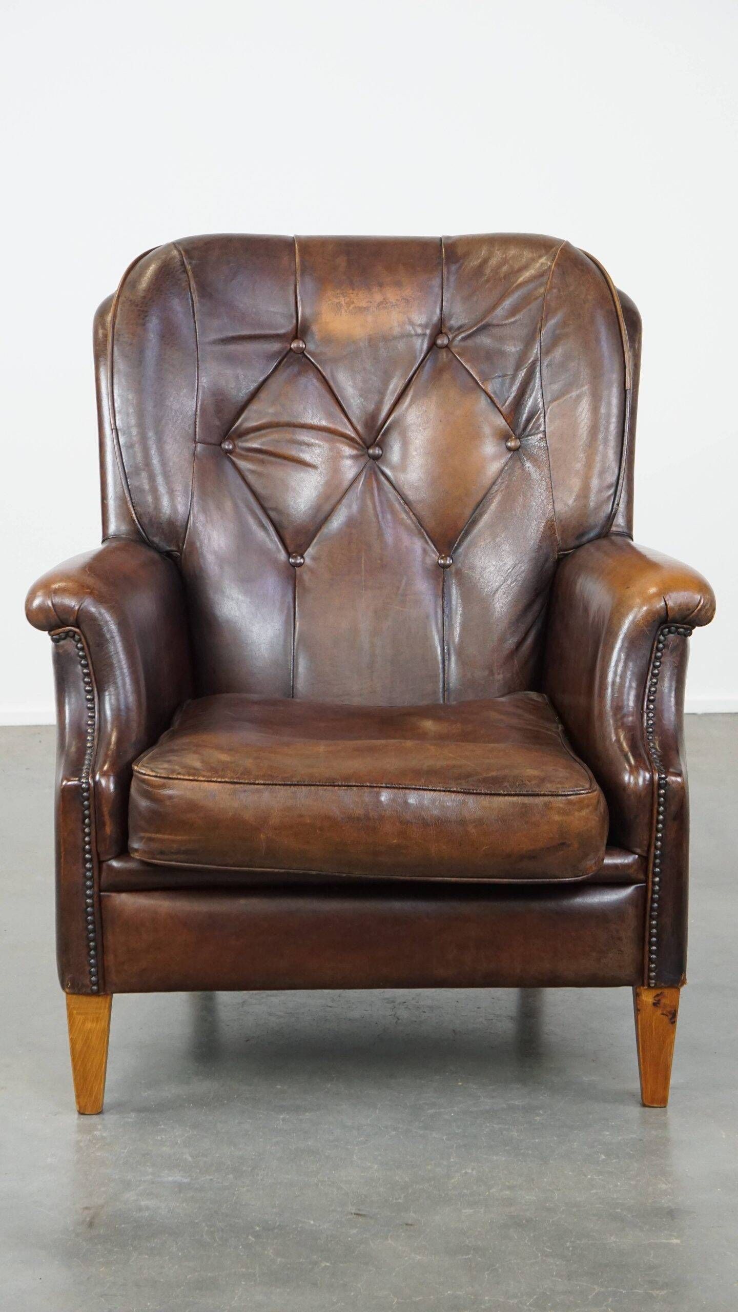 Vintage sheepskin armchair in a dark cognac colour with a comfortable seat