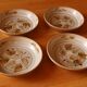 Four bowl-shaped plates in vintage Niderviller stoneware with plant decoration