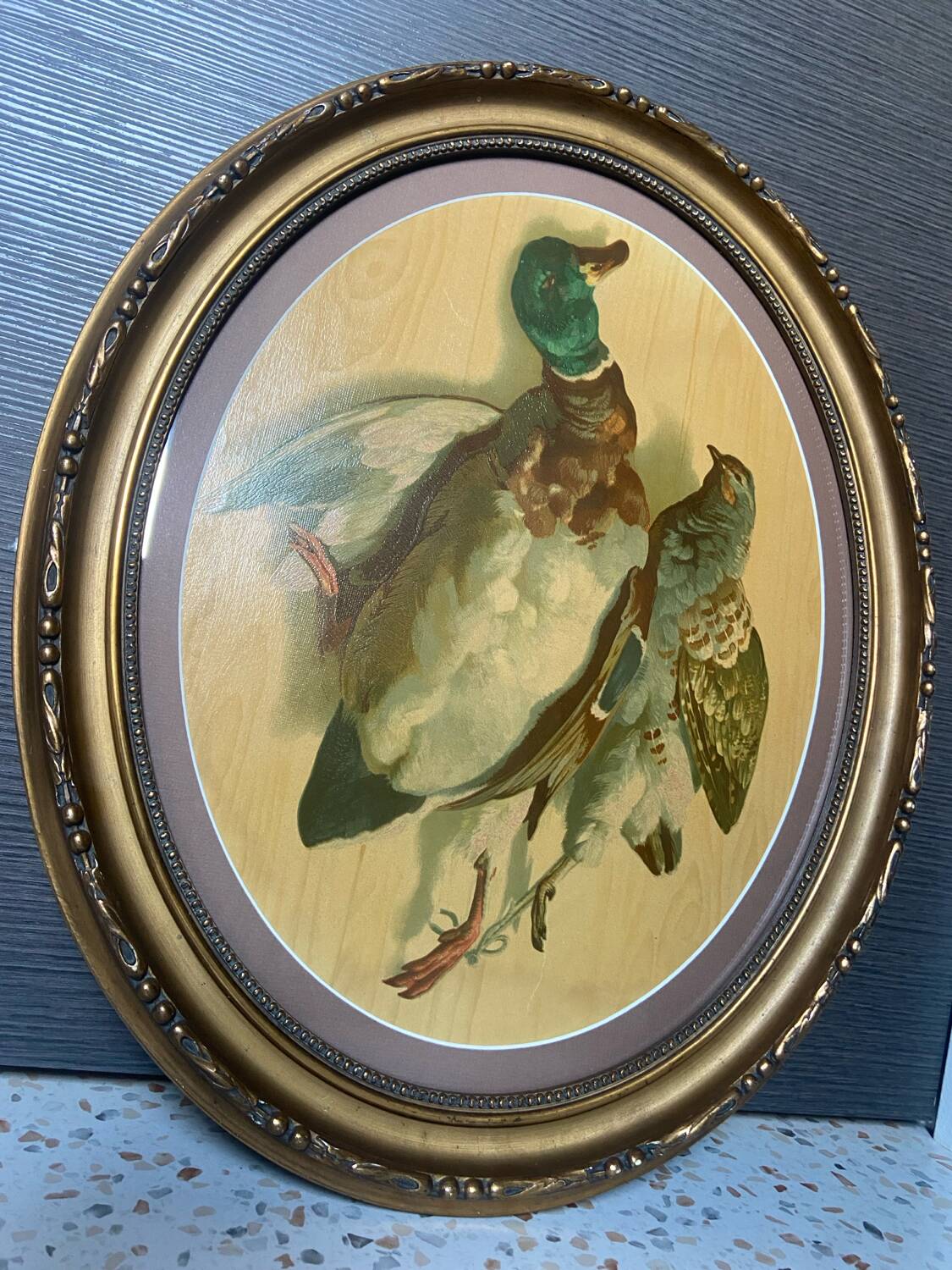 Antique oval frame with an oil painting of green collars