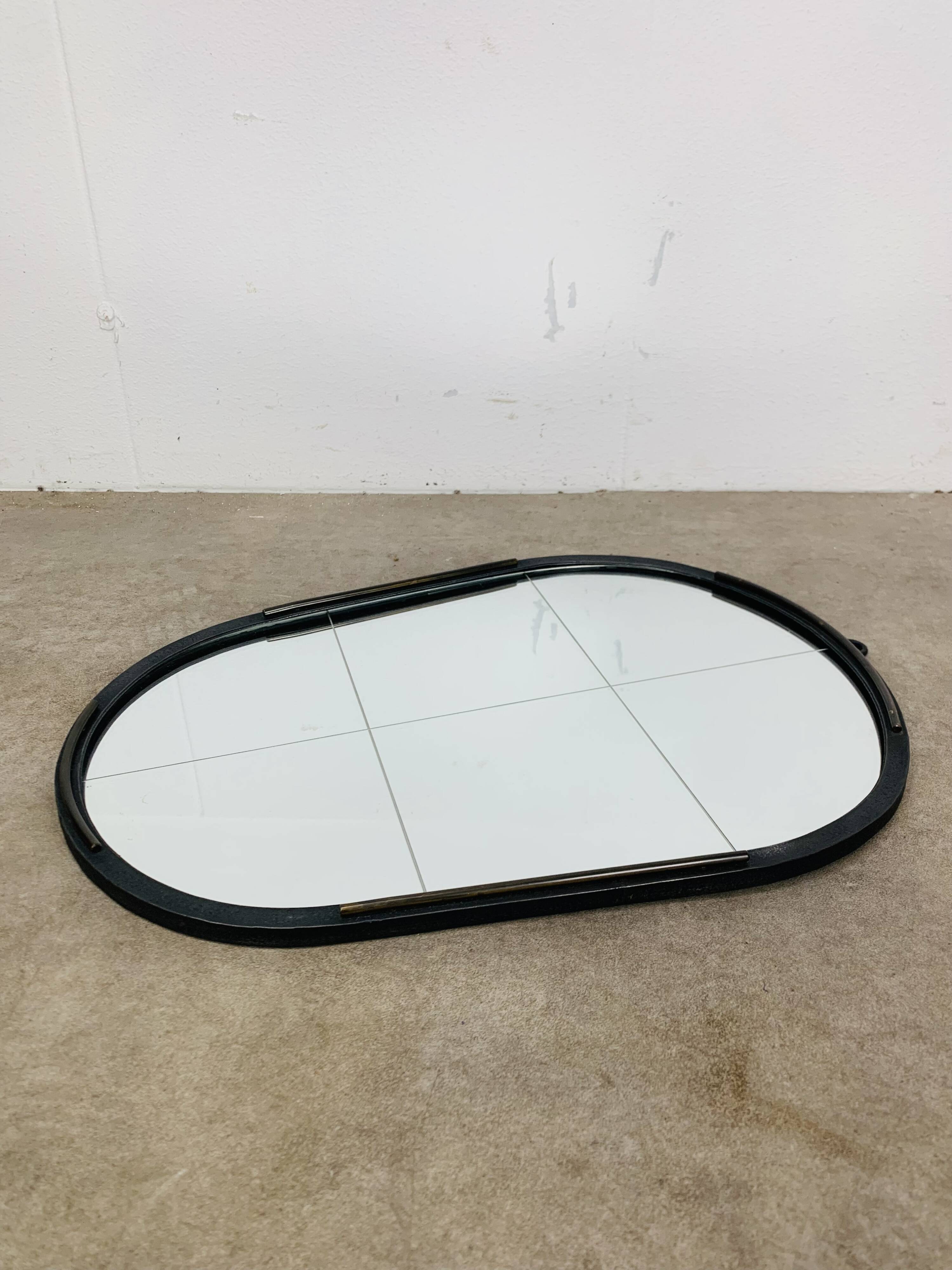 Oval mirror from the 1950s, wrought iron and brass.
