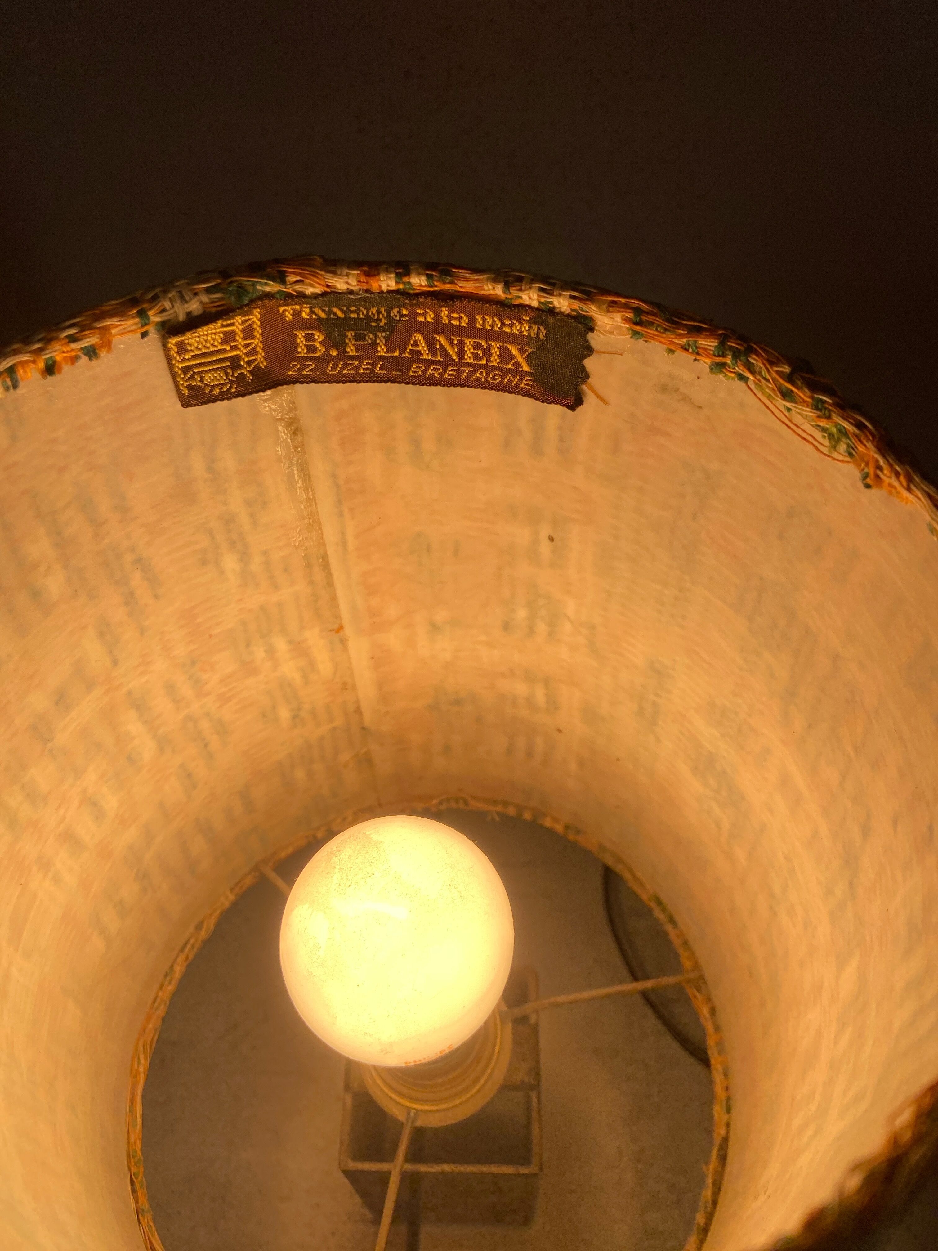 Small modernist table lamp with hand-woven shade.