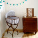 Vintage rattan cradle and its wheeled support
