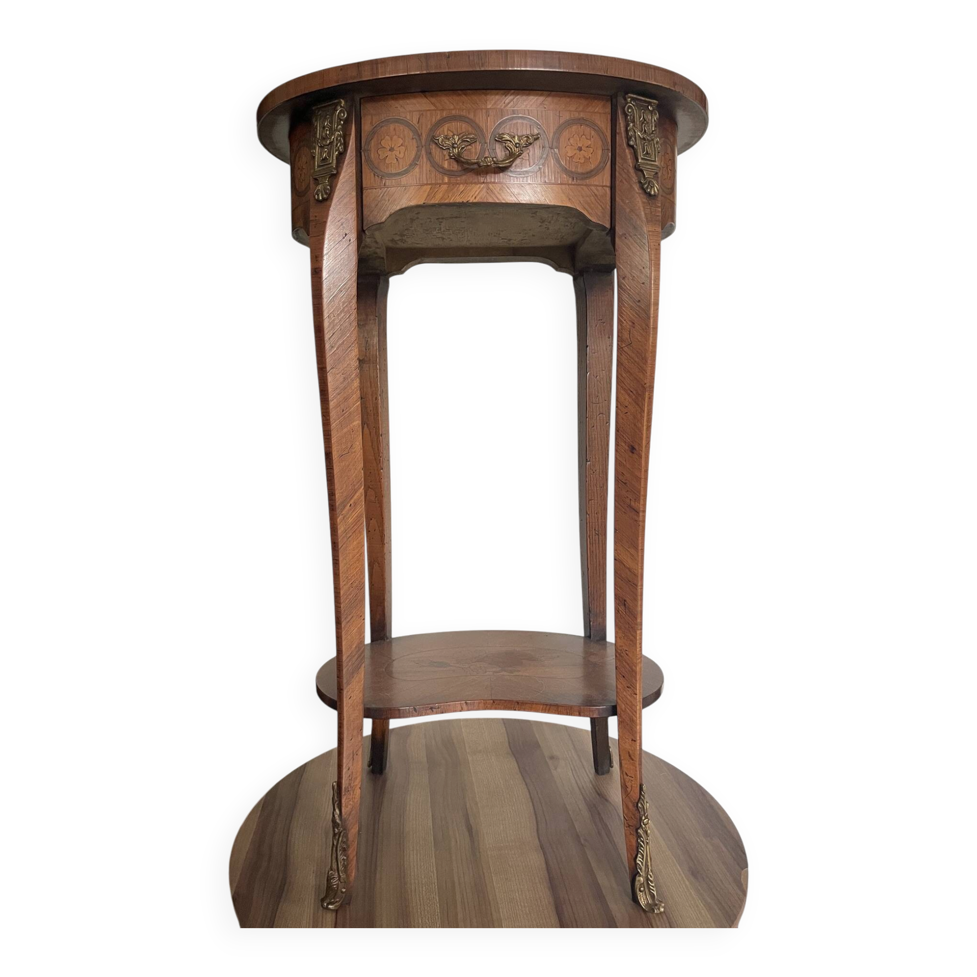 Oval bedside table from the Transition period in marquetry and bronze.