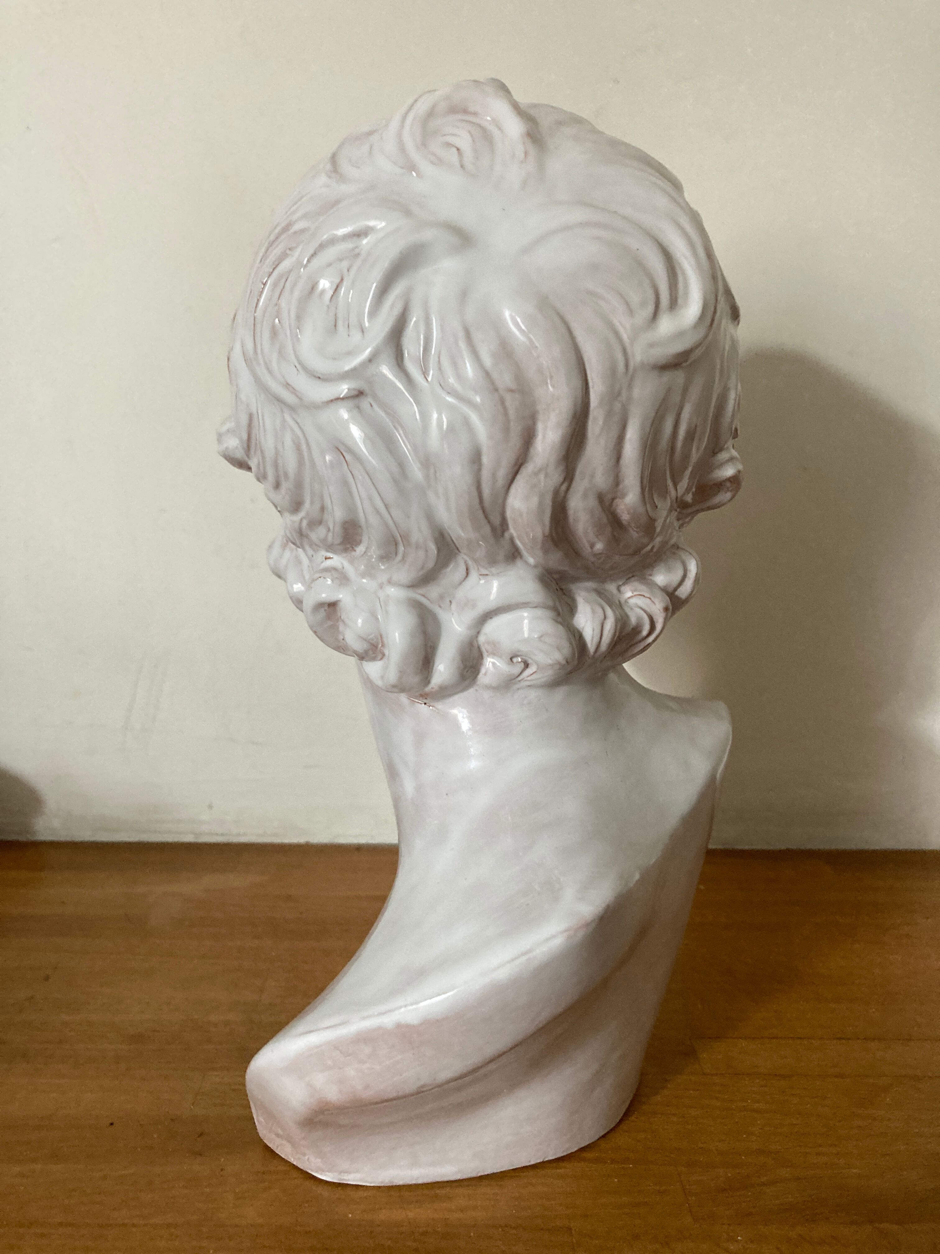 White enamelled terracotta Eros bust