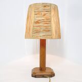 Lamp base in saddle stitched leather and raffia lampshade.
