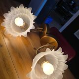 Frosted glass tulip wall sconces with brass arms.