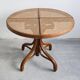 Round dining table in curved wood with a rattan top by Mundus, 1960s.