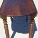 Walnut drop-leaf table with honey spoon legs.