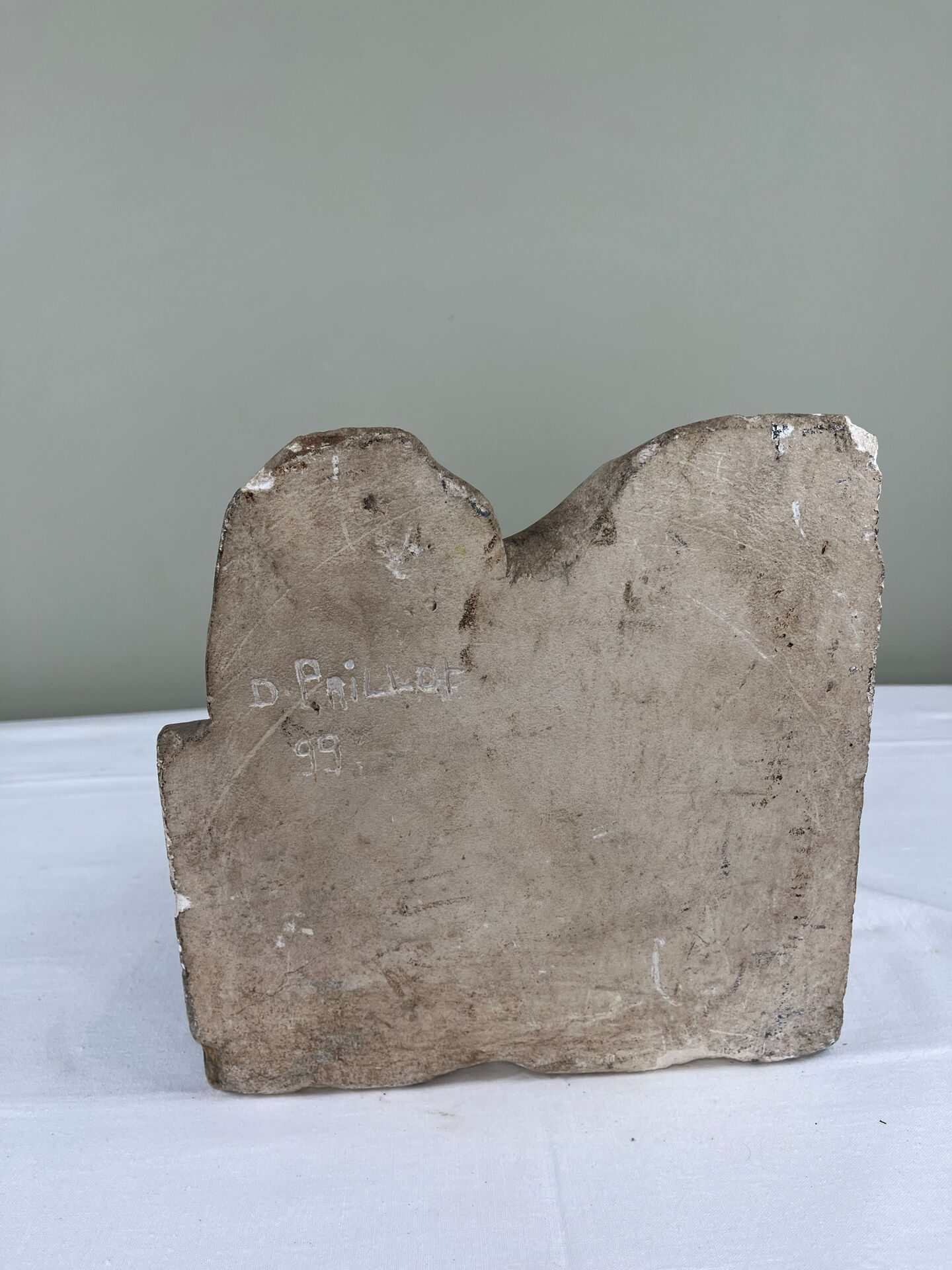 Stone sculpture, two feet on a block, signed D. Paillot.