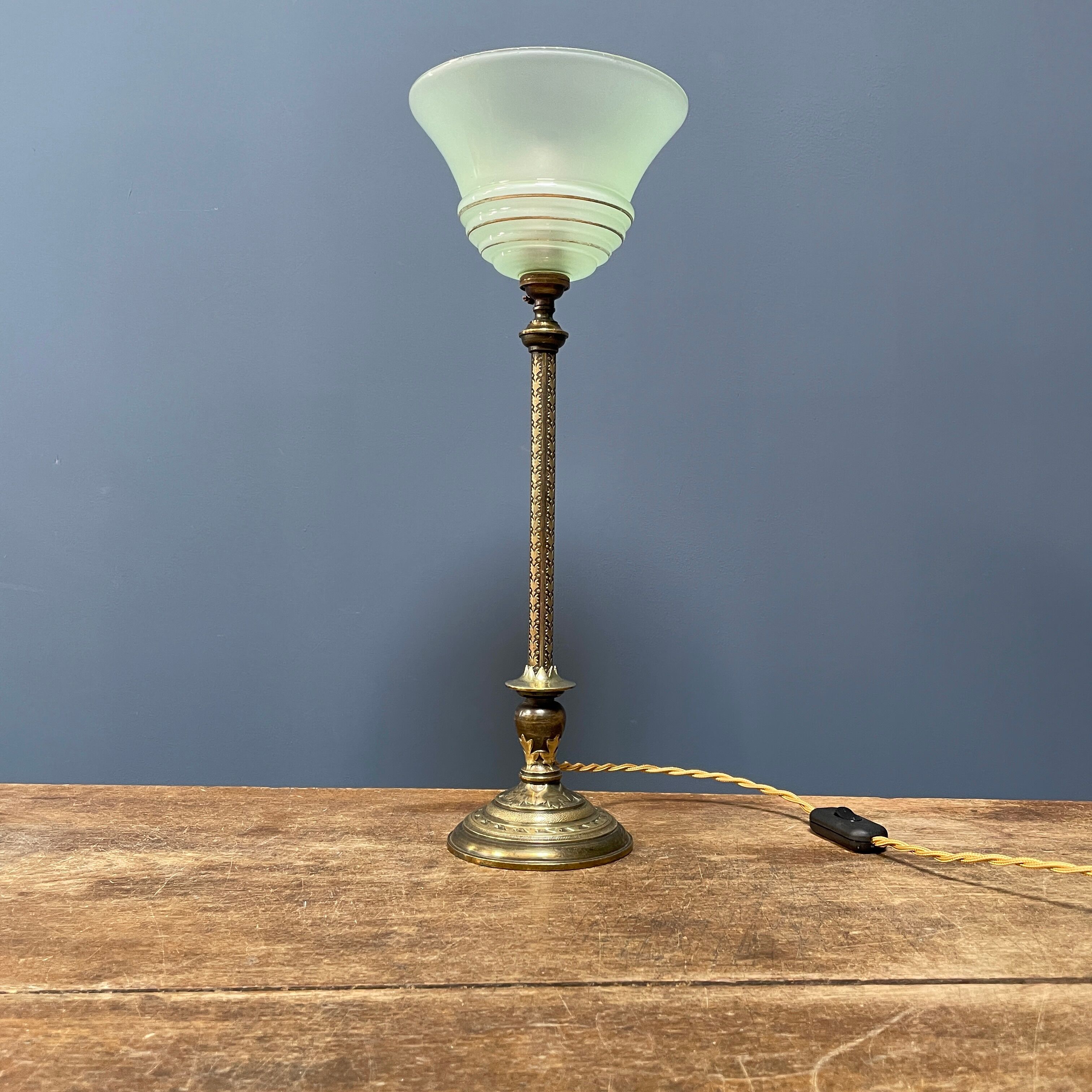 Ornate brass table lamp with mint green glass shade