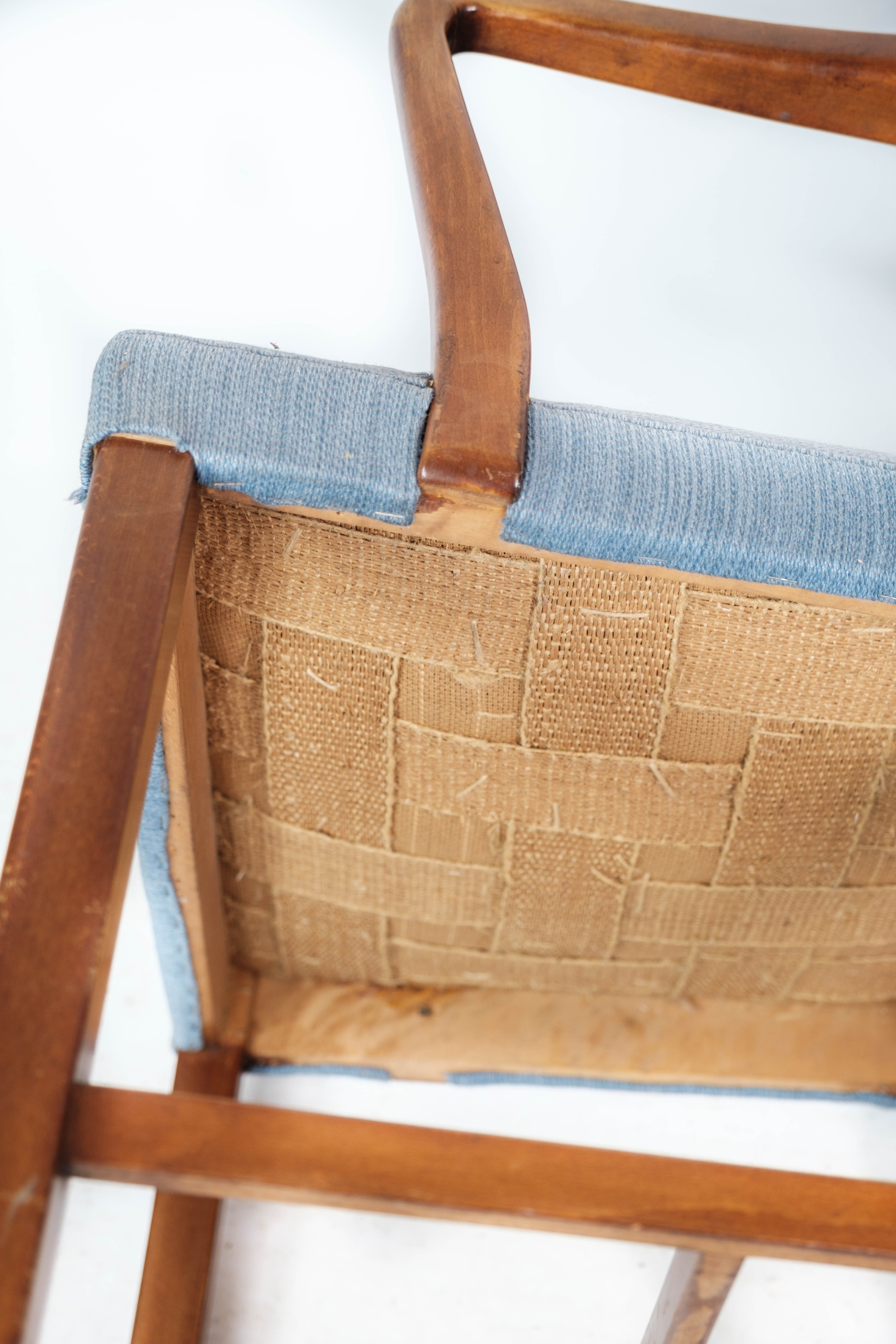 Armchair in mahogany and upholstered with light blue fabric by Fritz Hansen