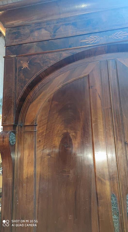 A walnut wardrobe with marquetry and boxwood stringing, dating from the Consulate period, circa 1810.