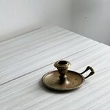 Brass candle holder with handle.