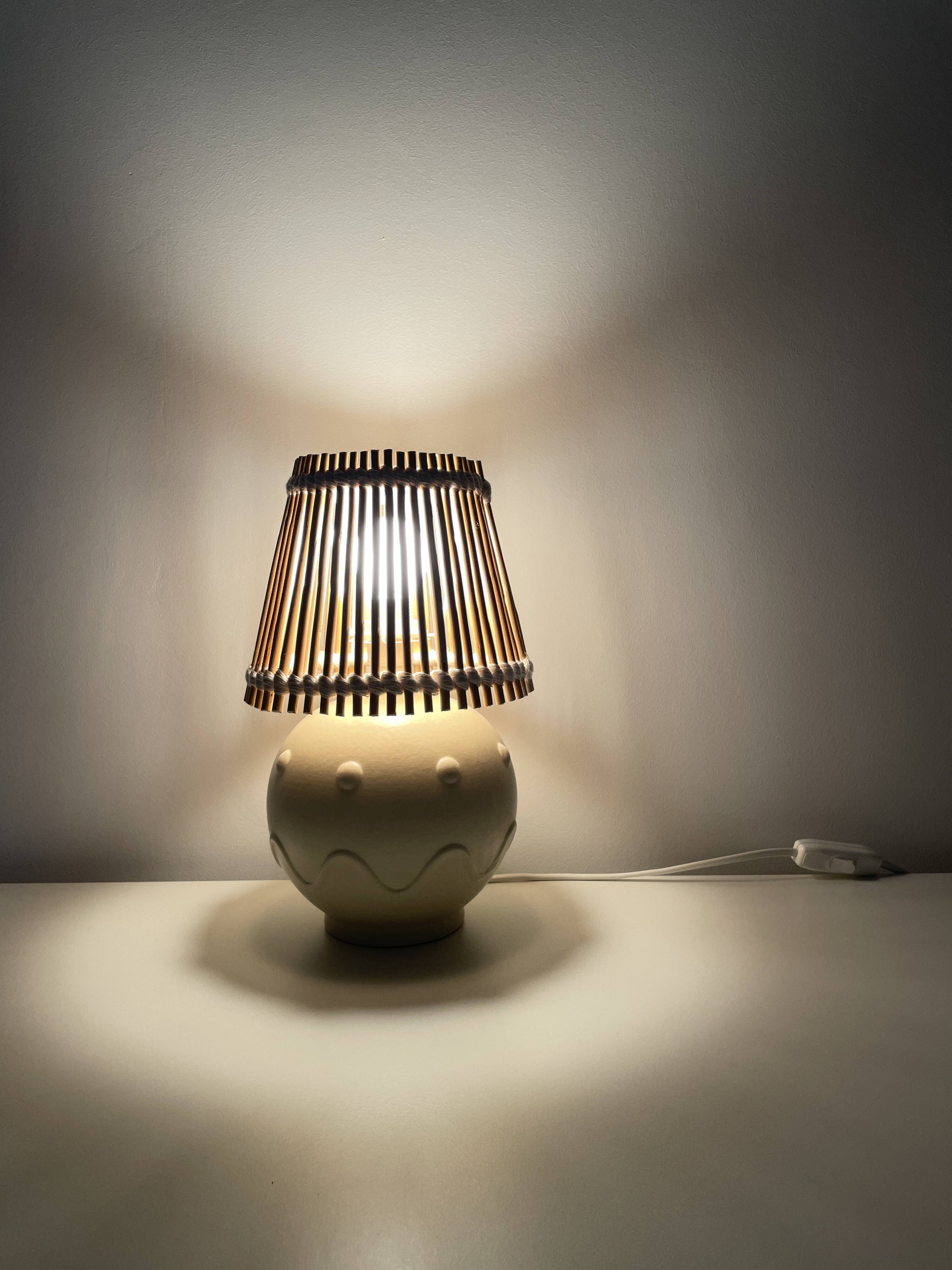 Vintage ceramic lamp with wicker and cotton shade.