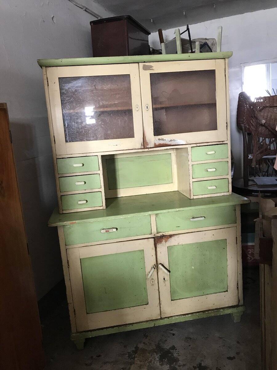 Vintage wooden kitchen cupboard painted green and beige, with glass doors - 1930s