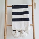 Hand-woven plaid with black stripes and white pompoms