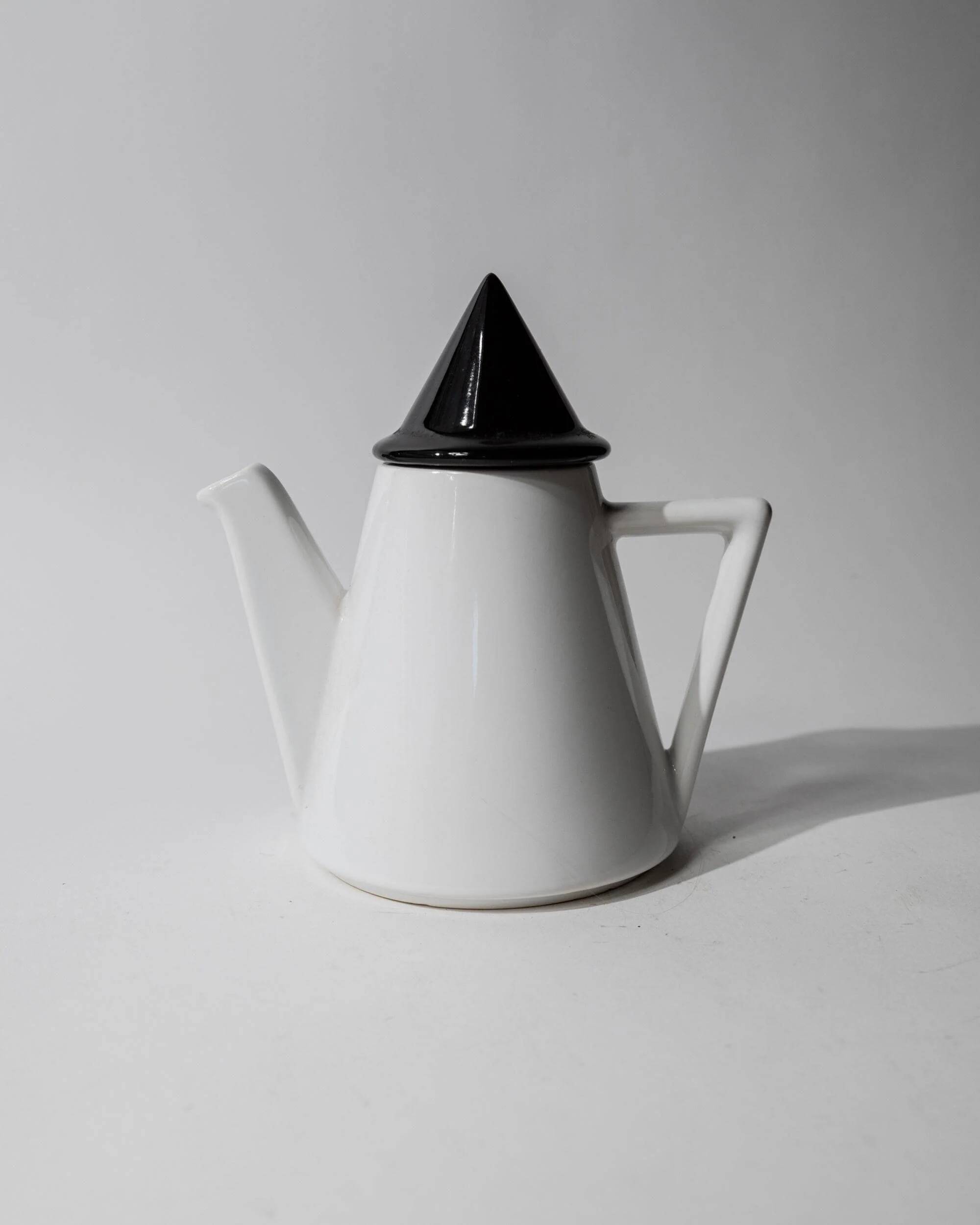 Vintage ceramic coffee pot or teapot from the 1980s, postmodern Memphis design, black and white triangles.