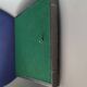 Pewter mirror on a brutalist-style wooden stand