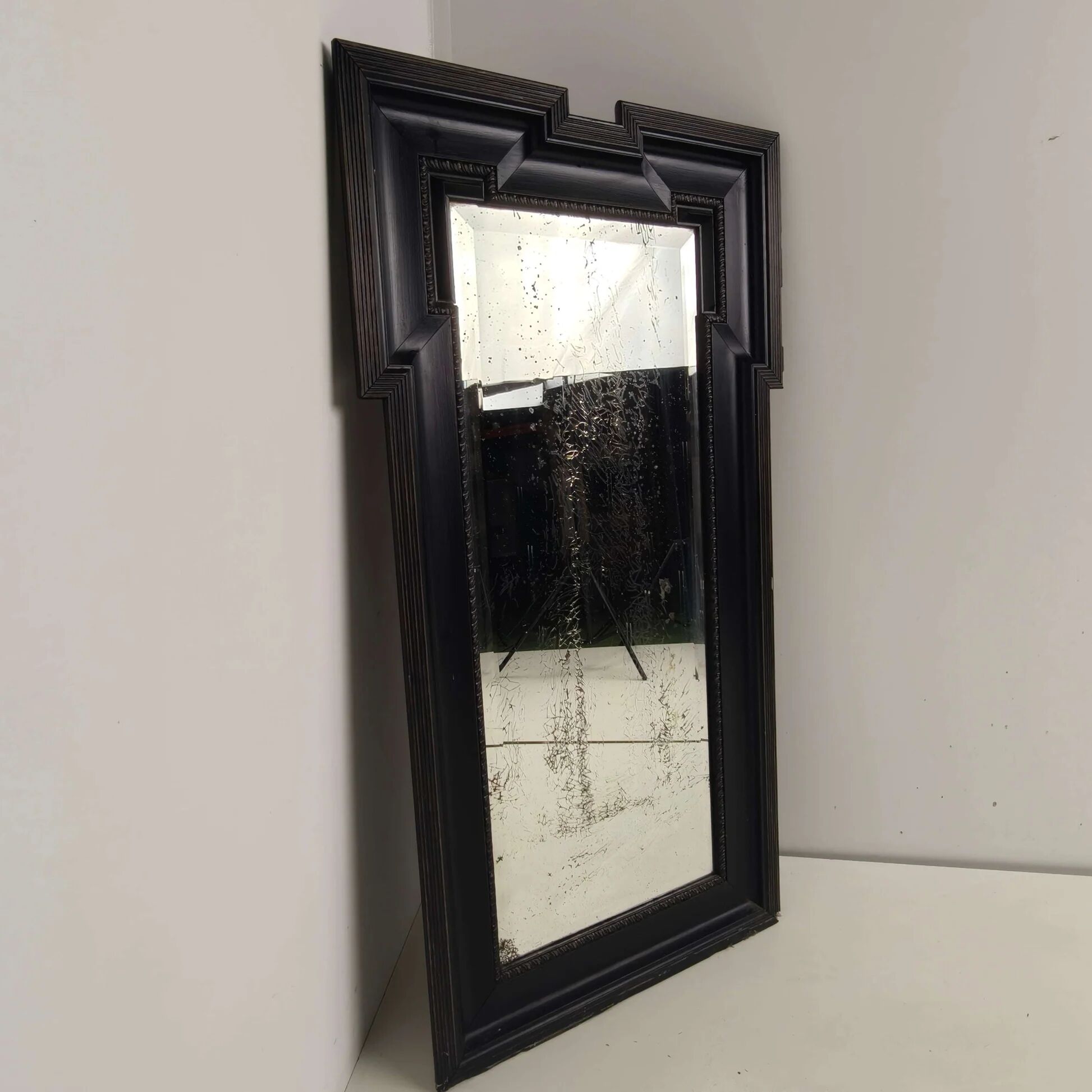 Late 19th century ebonised mirror with original foxed glass