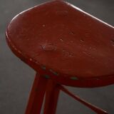Pair of patinated wooden stools painted red with flared legs, 1950s-1960s.