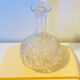 19th-century liqueur carafe in glass adorned with relief patterns.