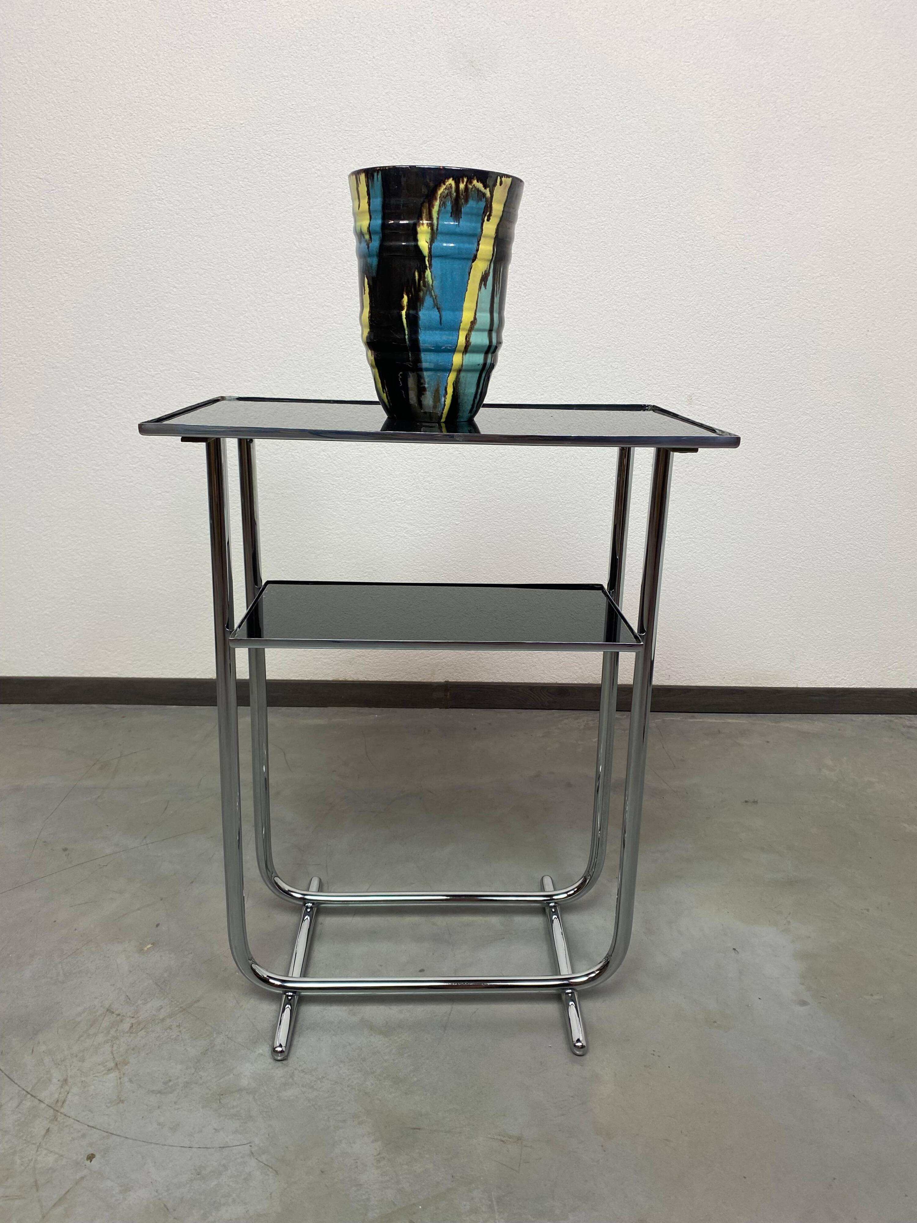 Bauhaus side table with a black glass top