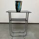 Bauhaus side table with a black glass top