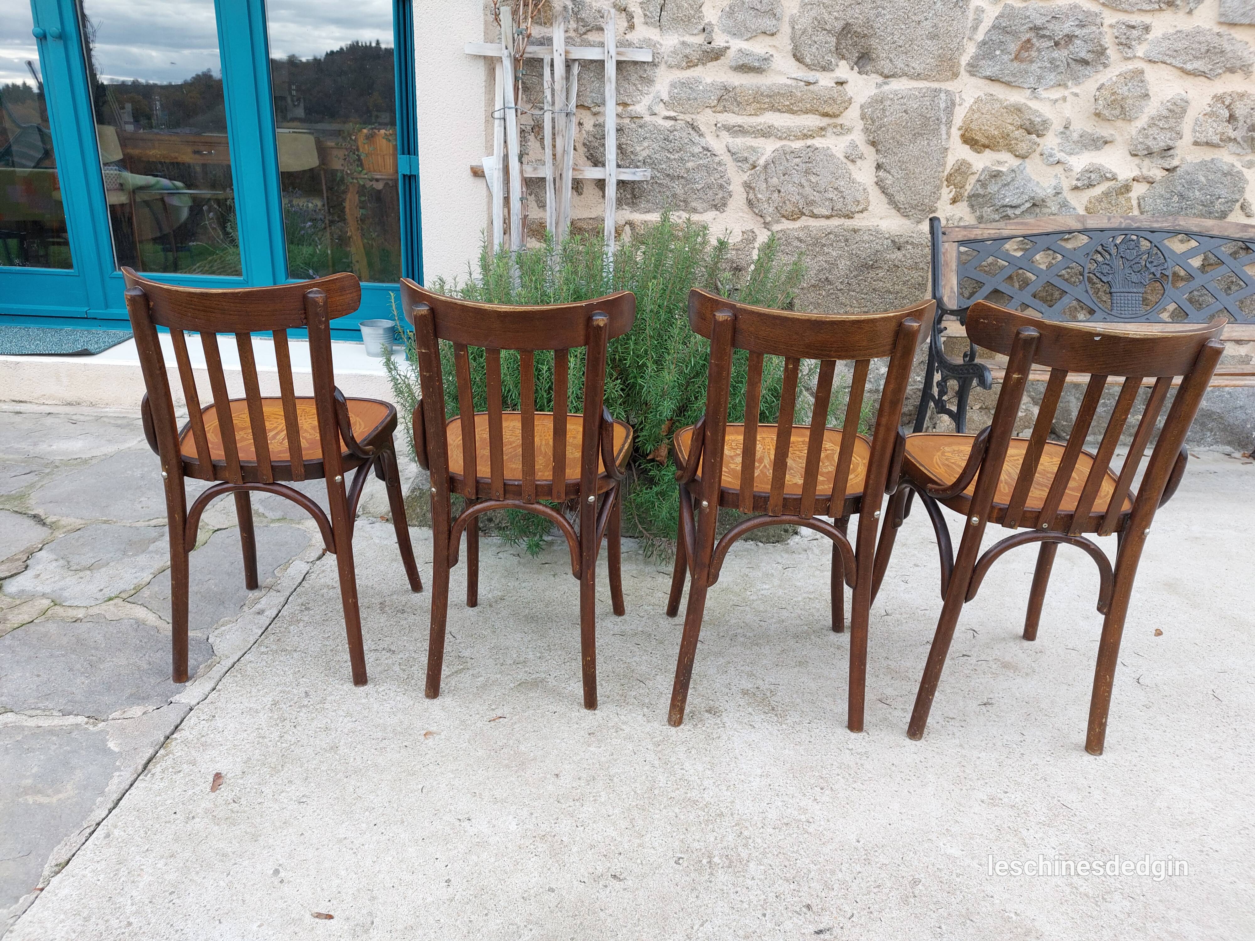 4 bentwood bistro chairs with a pattern on the seat