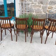 4 bentwood bistro chairs with a pattern on the seat