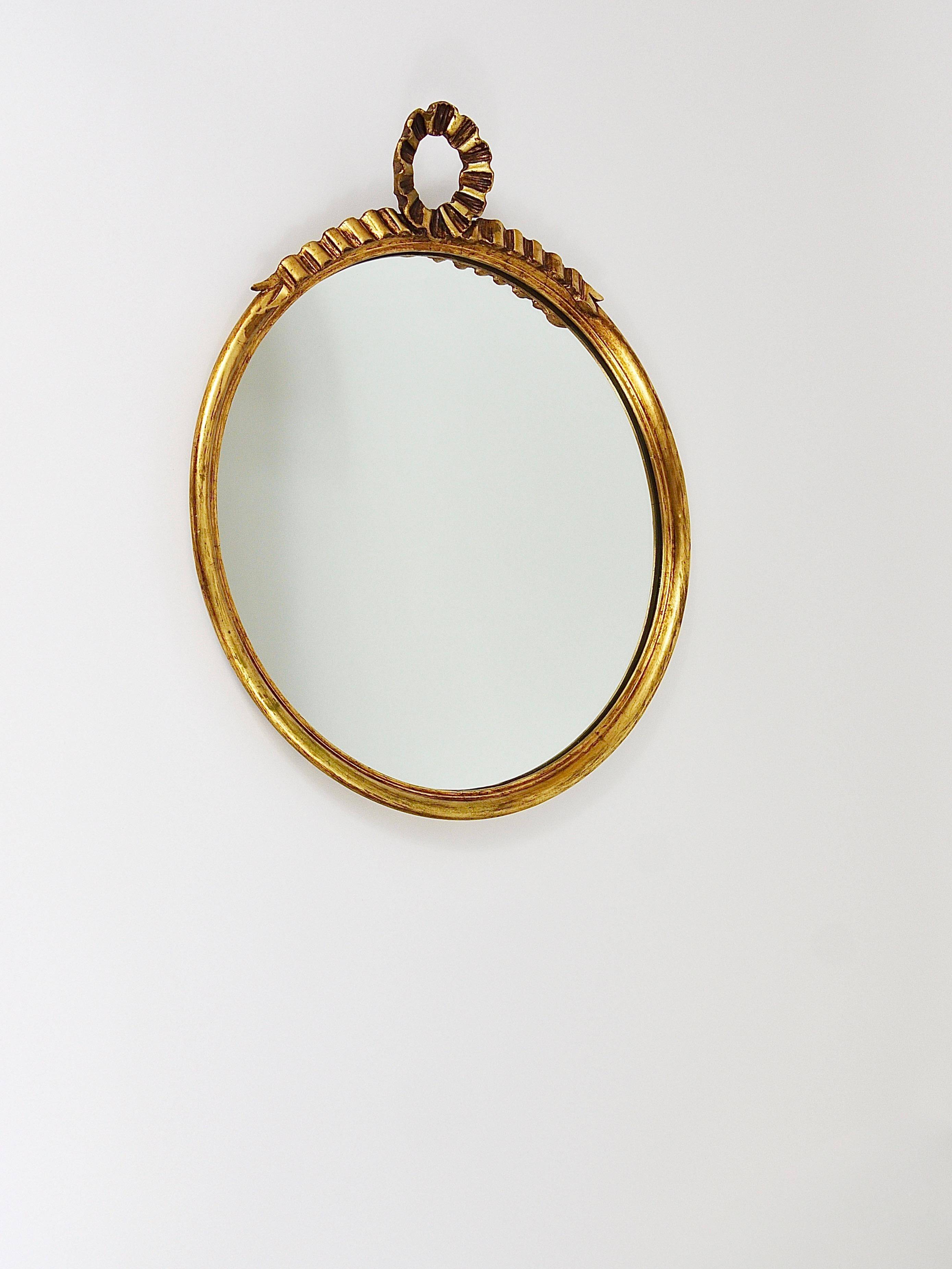 Round wall mirror in gilded wood, mid-century, C. Allodi & G. Subelli, Italy, 1950s.