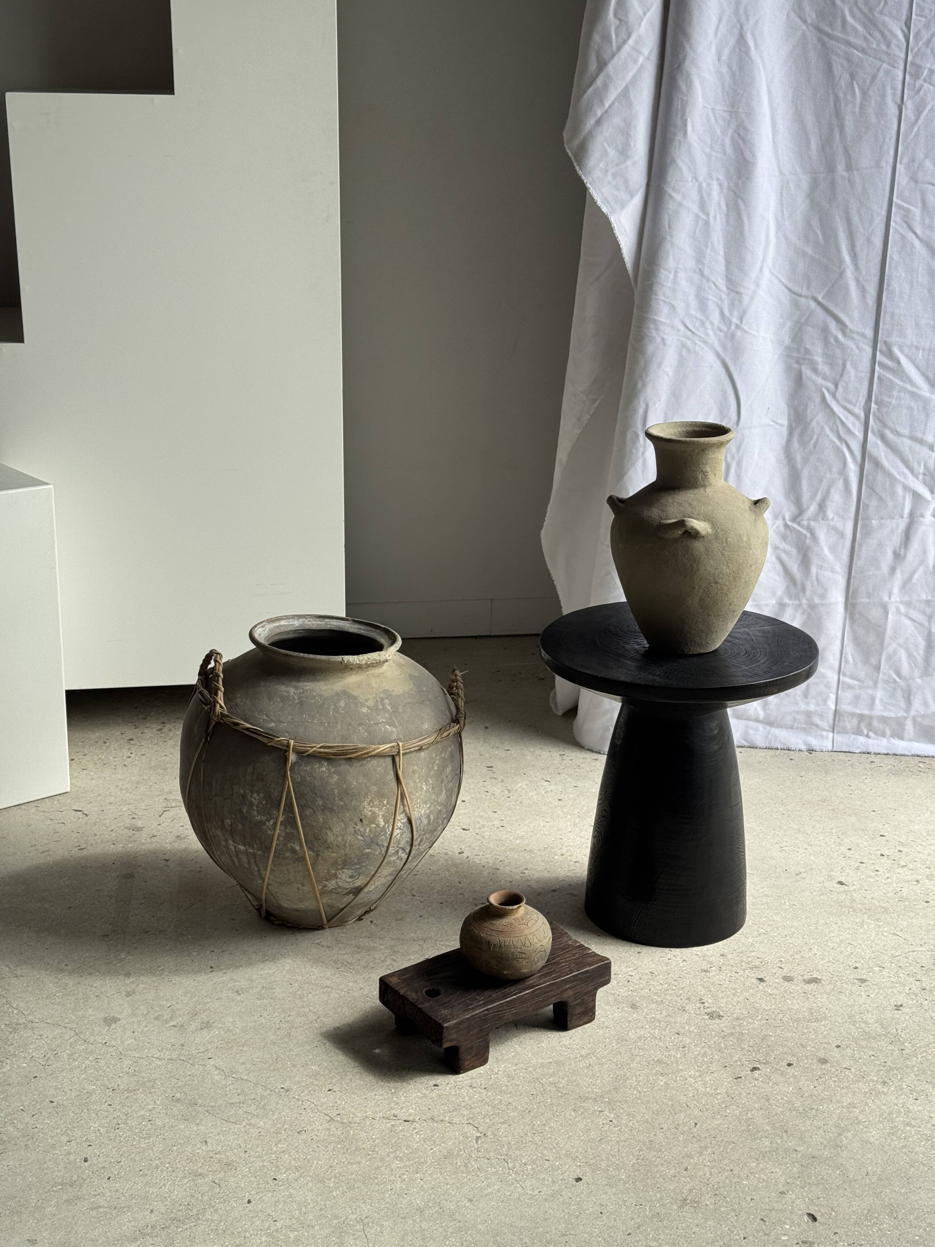 Black solid mango side table (monoxyle) with conical legs