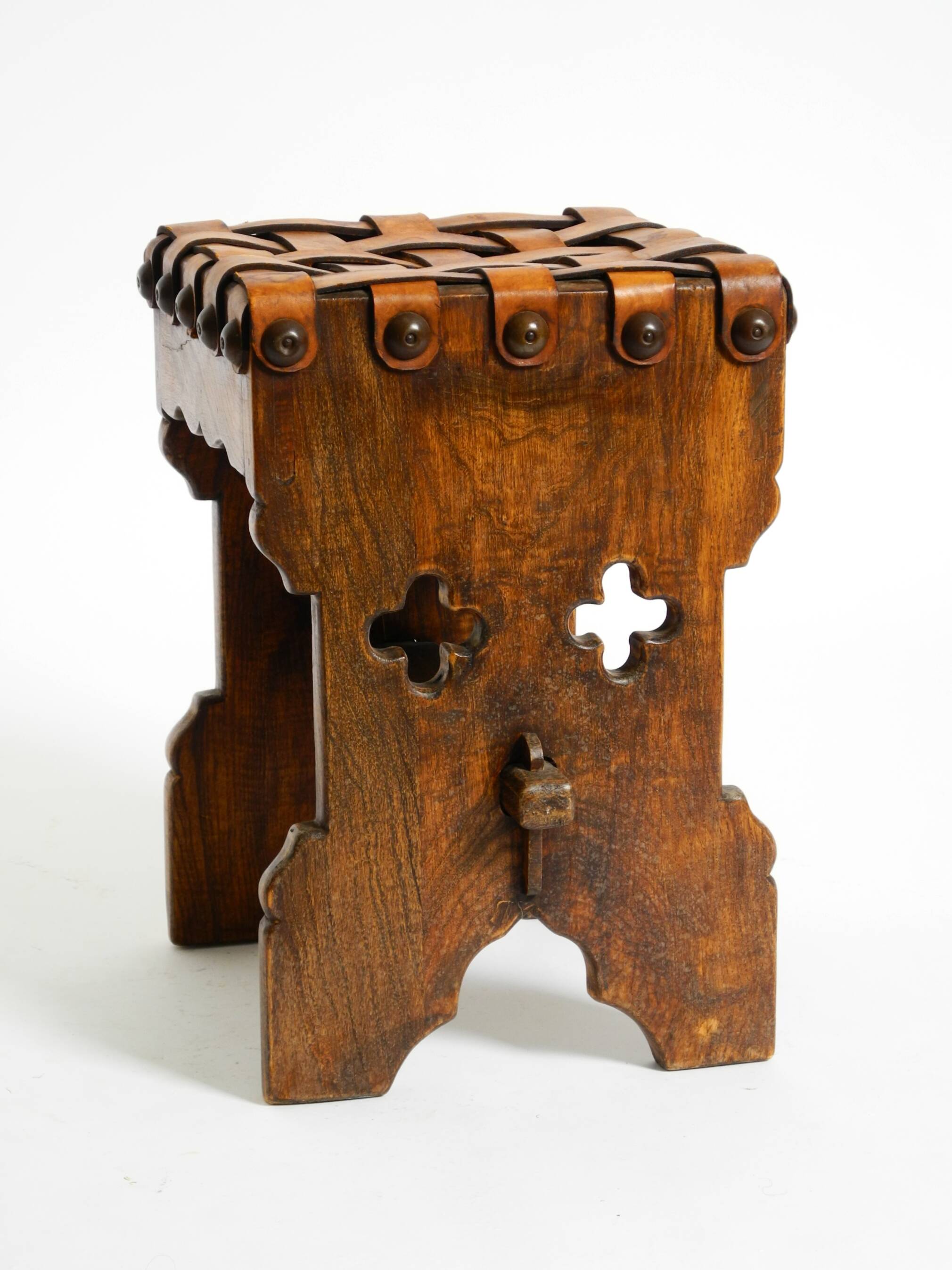 Beautiful 1940s oak stool with a seat made of leather straps