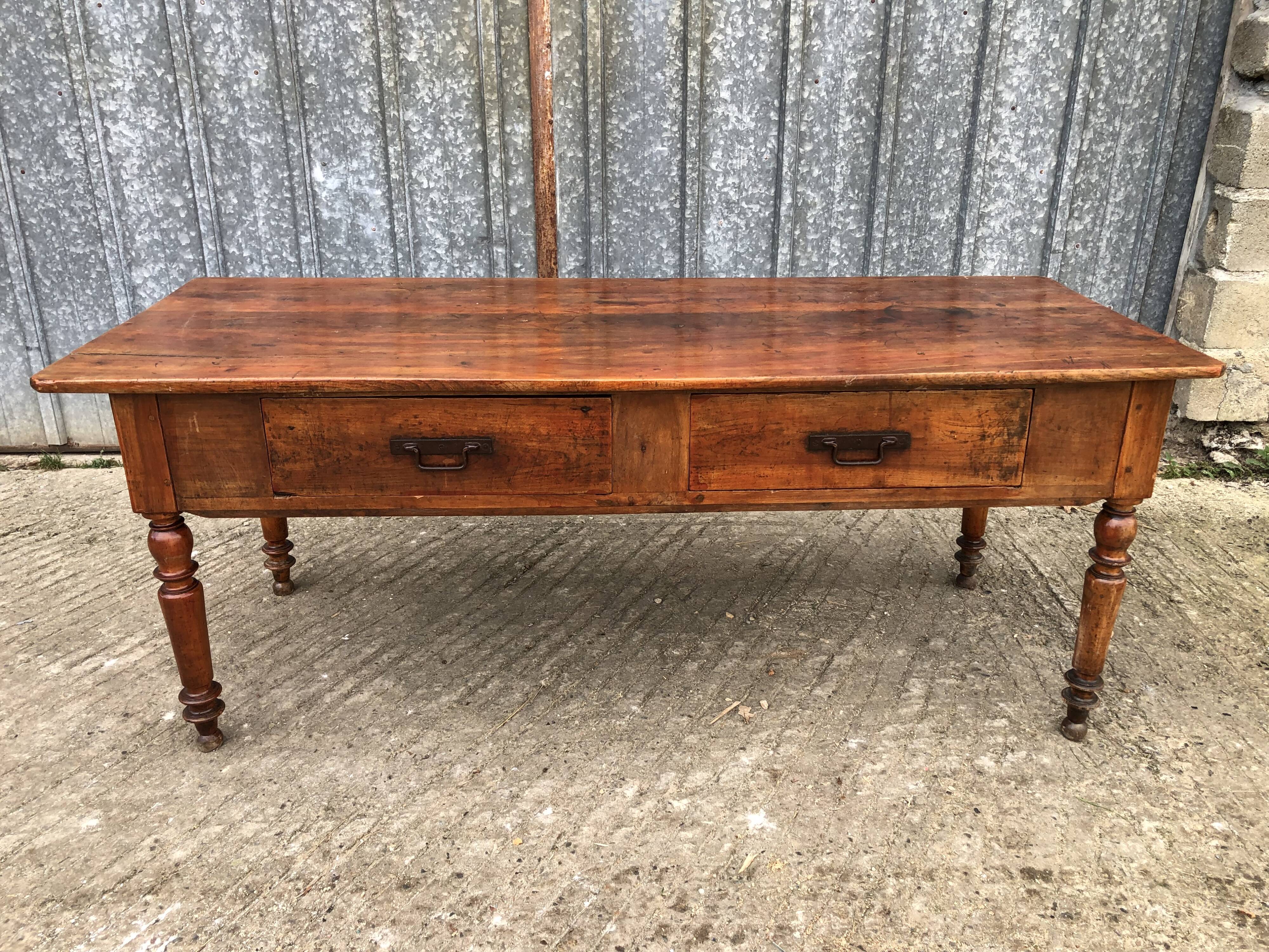 Old farmhouse table in solid cherry wood with 2 front drawers.