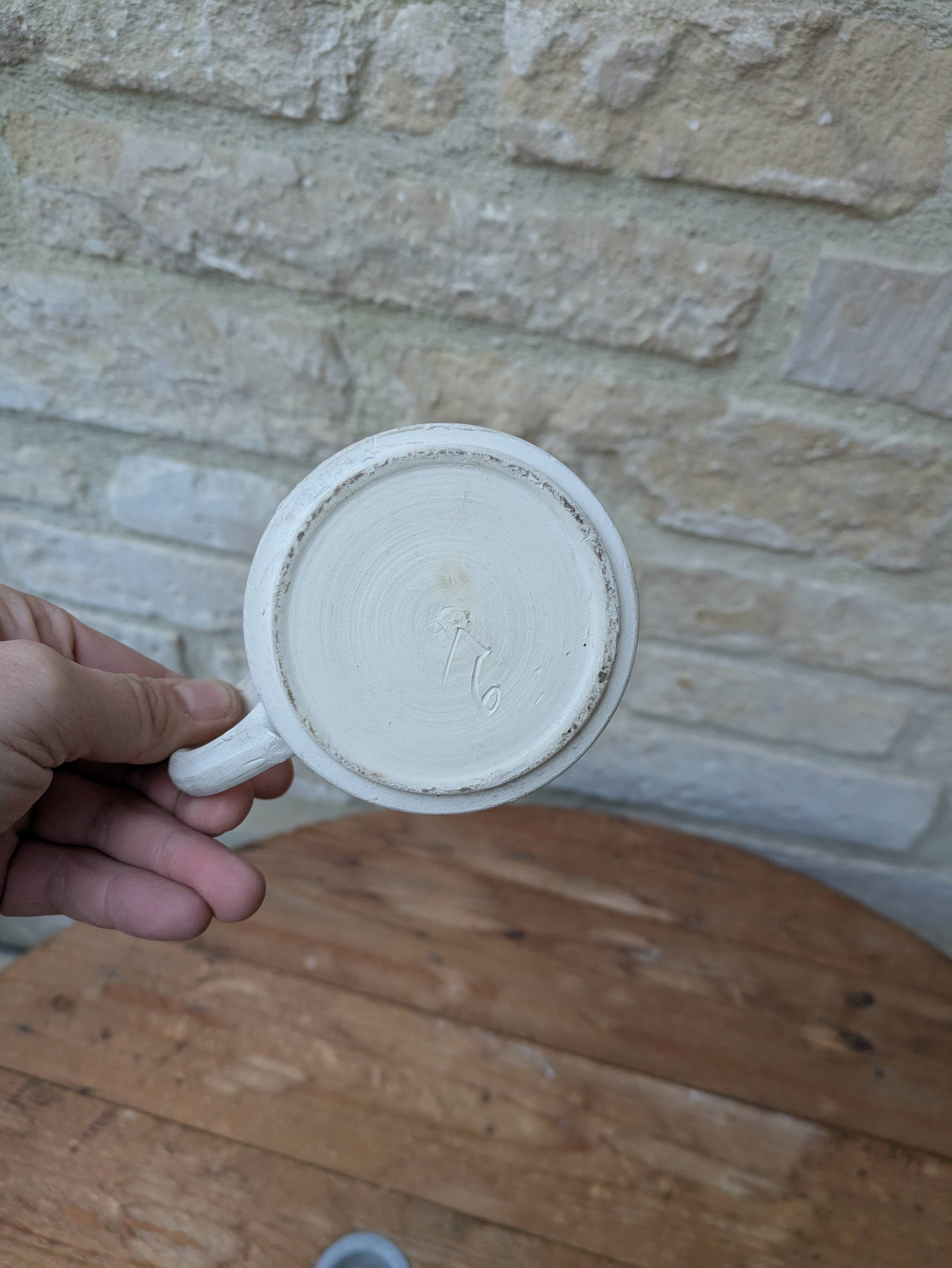 Old terracotta mug with glazed interior