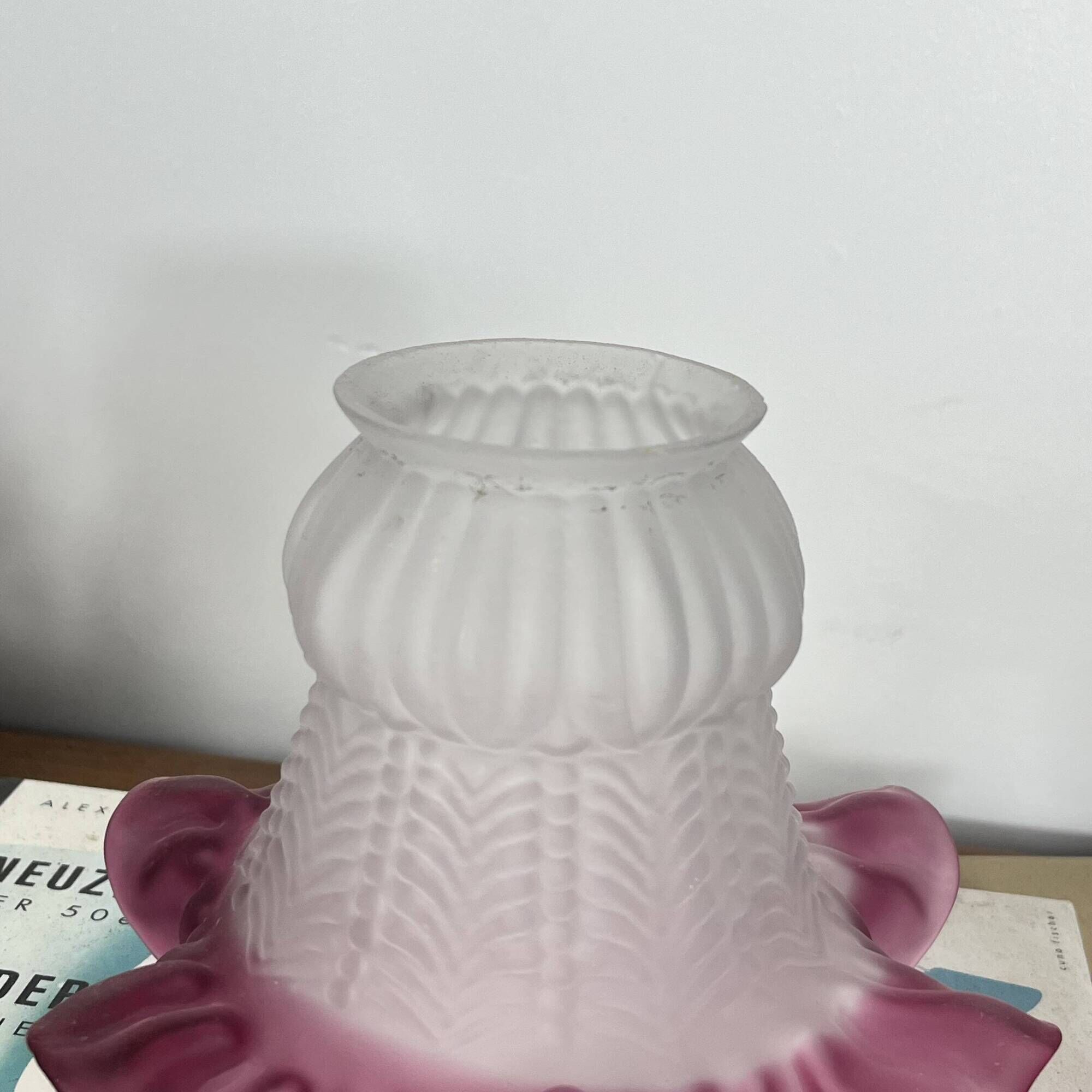 Antique tulip lampshade in transparent glass with a red rim.