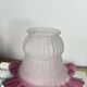 Antique tulip lampshade in transparent glass with a red rim.