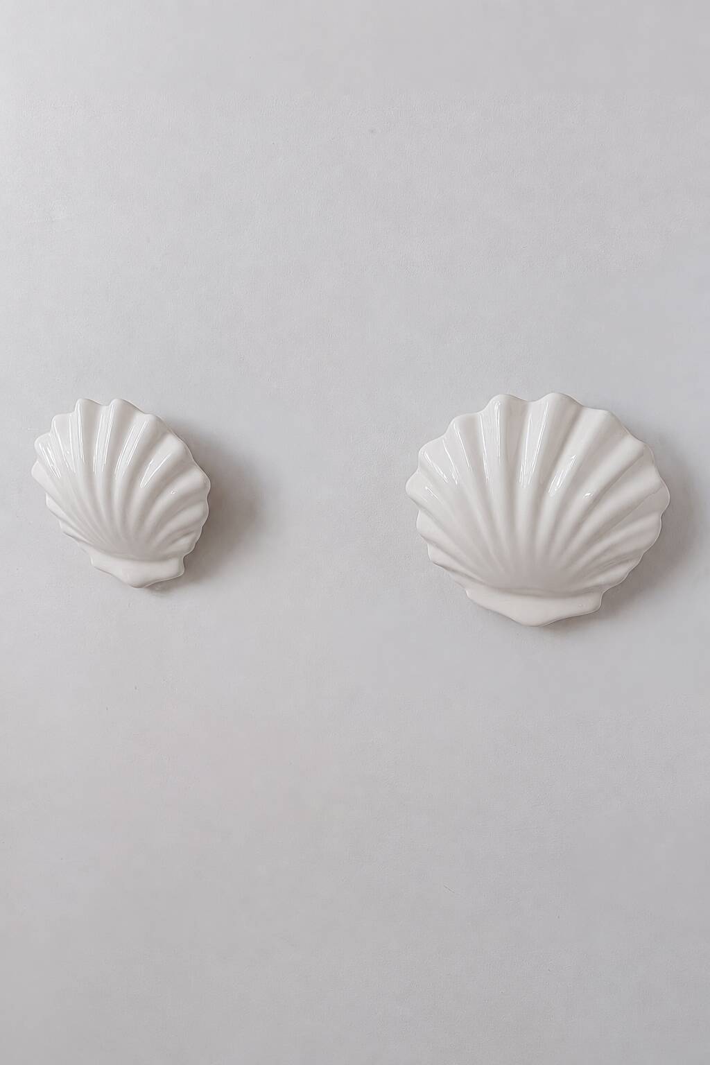 Vintage pair of white porcelain wall lights, France 1970.
